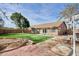 Beautiful backyard featuring a covered patio, a barbecue grill, and artificial grass at 7259 W Tina Ln, Glendale, AZ 85310