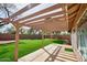 View of a covered patio and a backyard with pristine artificial grass at 7259 W Tina Ln, Glendale, AZ 85310