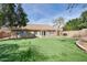 A well-maintained backyard features artificial grass and a covered patio at 7259 W Tina Ln, Glendale, AZ 85310