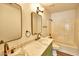 Bathroom featuring double mirrors, marble countertops and a shower with bathtub at 7259 W Tina Ln, Glendale, AZ 85310