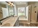 Modern bathroom with dual vanity, framed mirror, bath tub and a shower at 7259 W Tina Ln, Glendale, AZ 85310