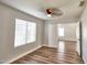 Bedroom features a ceiling fan, a large window and a door opening to another room at 7259 W Tina Ln, Glendale, AZ 85310