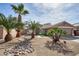 Charming home with mature palm trees, desert landscaping, and a two-car garage at 7259 W Tina Ln, Glendale, AZ 85310