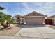 Charming single-story home with desert landscaping, a spacious driveway, and a two-car garage at 7259 W Tina Ln, Glendale, AZ 85310