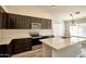 Well-lit kitchen featuring stainless steel appliances, modern cabinetry, and a large island with a sink at 7259 W Tina Ln, Glendale, AZ 85310