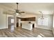 Open-concept kitchen with a center island, dark wood cabinetry, stainless steel appliances, and wood flooring at 7259 W Tina Ln, Glendale, AZ 85310