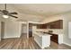 Contemporary kitchen with stainless steel appliances, a large island with sink, wood flooring and recessed lighting at 7259 W Tina Ln, Glendale, AZ 85310