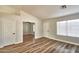 Bright and airy living room featuring neutral walls, modern flooring, and multiple entry doors at 7259 W Tina Ln, Glendale, AZ 85310