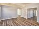 Neutral living room with luxury vinyl plank flooring, modern archway, and neutral paint at 7259 W Tina Ln, Glendale, AZ 85310