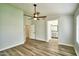 Spacious main bedroom showcasing wood-look floors, a ceiling fan, and access to the ensuite bathroom at 7259 W Tina Ln, Glendale, AZ 85310