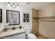 Bathroom featuring a walk-in shower with decorative tile and a vanity with a granite countertop at 7270 W Tina Ln, Glendale, AZ 85310