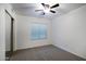 Neutral bedroom with a ceiling fan, carpeted floors, and a mirrored closet door at 7270 W Tina Ln, Glendale, AZ 85310