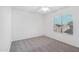 A bright bedroom with neutral carpet, ceiling fan, and a window with blind coverings at 7270 W Tina Ln, Glendale, AZ 85310