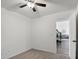 Neutral bedroom with a ceiling fan, carpeted floors, and views into the hallway at 7270 W Tina Ln, Glendale, AZ 85310