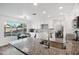 Bright kitchen with white cabinets, granite counters, stainless steel appliances, and views of the backyard at 7270 W Tina Ln, Glendale, AZ 85310