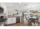 Bright kitchen with white cabinets, stainless appliances, and seamless flow into the sunny living area at 7270 W Tina Ln, Glendale, AZ 85310