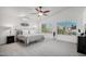 Serene main bedroom with vaulted ceilings, carpeted floors, and large windows overlooking the neighborhood at 7270 W Tina Ln, Glendale, AZ 85310