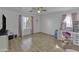 Bright bedroom with neutral walls, window, and wood-look tile flooring provides a serene and customizable living space at 7703 S 68Th Dr, Laveen, AZ 85339