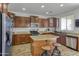 Spacious kitchen featuring stainless steel appliances and a center island at 7703 S 68Th Dr, Laveen, AZ 85339