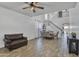 Open-concept living room featuring a staircase and elegant chandelier at 7703 S 68Th Dr, Laveen, AZ 85339