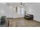 Bright living room with wood-look floors and decorative accents at 7703 S 68Th Dr, Laveen, AZ 85339