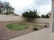 Well-maintained backyard with green grass, gravel, privacy fence, and ample space for outdoor activities at 7728 W Via Montoya Dr, Peoria, AZ 85383