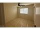 This bedroom features tile floors, a ceiling fan, and a window for natural light at 7728 W Via Montoya Dr, Peoria, AZ 85383