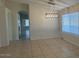 Dining room featuring tile floors, large windows, and modern light fixtures at 7728 W Via Montoya Dr, Peoria, AZ 85383