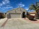 Charming single-story home featuring a two car garage, desert landscaping, and a well-maintained lawn at 7728 W Via Montoya Dr, Peoria, AZ 85383