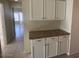 Hallway featuring a granite countertop butler's pantry and tile floors at 7728 W Via Montoya Dr, Peoria, AZ 85383