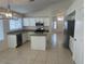 Well-lit kitchen with a stainless steel dishwasher, granite counters, and a modern light fixture at 7728 W Via Montoya Dr, Peoria, AZ 85383