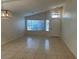 Bright living room with tile floors, large windows, and modern light fixtures at 7728 W Via Montoya Dr, Peoria, AZ 85383