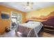 Vibrant bedroom with sliding door to patio and sunset mural wall at 8103 E Southern Ave # 25, Mesa, AZ 85209