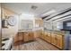 Well-lit kitchen featuring wood floors, light wood cabinets, and stainless steel appliances at 8103 E Southern Ave # 25, Mesa, AZ 85209