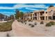 Community walkway landscaped with desert plants and mature trees and leading to residential buildings at 8231 N 21St Dr # E101, Phoenix, AZ 85021