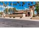 Community building shows desert landscaping, manicured shrubs, and tall palm trees against a blue sky at 8231 N 21St Dr # E101, Phoenix, AZ 85021