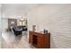 Inviting living room with modern accent wall and wood-look flooring flows into comfortable seating area at 8231 N 21St Dr # E101, Phoenix, AZ 85021