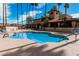 Community swimming pool featuring clear blue water, poolside furniture, and views of the surrounding buildings at 8231 N 21St Dr # E101, Phoenix, AZ 85021