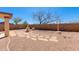 Spacious backyard with a decorative fountain, minimalist landscaping, and privacy wall at 8250 S Hidden Trail Ct, Gold Canyon, AZ 85118