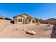 Backyard features desert landscaping, patio, rock features, and privacy wall at 8250 S Hidden Trail Ct, Gold Canyon, AZ 85118