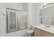 Bright bathroom featuring a shower-tub combination with sliding glass doors, vanity, and tiled floor at 8250 S Hidden Trail Ct, Gold Canyon, AZ 85118