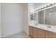 Bathroom with double sink vanity, framed mirror, and tile flooring, offering a functional space at 8250 S Hidden Trail Ct, Gold Canyon, AZ 85118