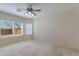 Comfortable bedroom with neutral walls, carpet, a ceiling fan, and natural light from the windows at 8250 S Hidden Trail Ct, Gold Canyon, AZ 85118