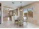 Cozy dining area featuring a glass table, elegant chairs, and a view into the living room at 8250 S Hidden Trail Ct, Gold Canyon, AZ 85118