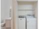 Convenient laundry closet with a white washer and dryer, and shelving at 8250 S Hidden Trail Ct, Gold Canyon, AZ 85118