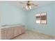 Versatile room with sink and cabinets, tile floor, ceiling fan, and window, perfect for a home office at 8250 S Hidden Trail Ct, Gold Canyon, AZ 85118