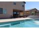 Backyard features a swimming pool, covered patio, and desert landscaping at 8420 S 40Th Dr, Laveen, AZ 85339