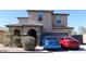 Two-story home featuring stacked stone accents, a two-car garage, and a tile roof at 8420 S 40Th Dr, Laveen, AZ 85339