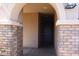 Inviting covered front porch with stone pillars leading to the entryway at 8420 S 40Th Dr, Laveen, AZ 85339