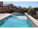 Backyard pool with waterfall feature, surrounded by desert landscaping and privacy fence at 8420 S 40Th Dr, Laveen, AZ 85339